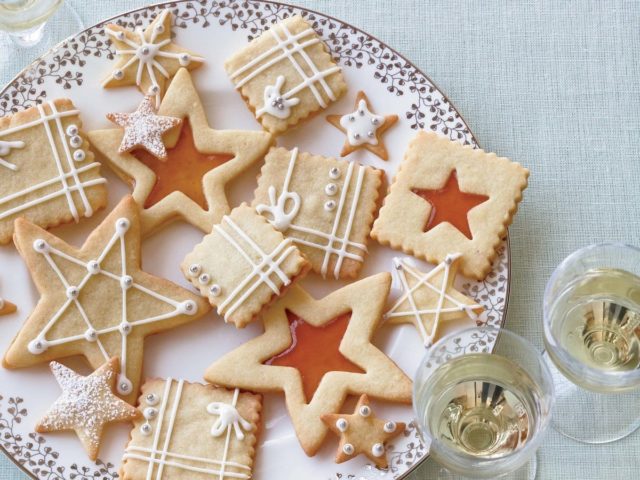 a platter of star-shaped and gift-shaped sugar cookies