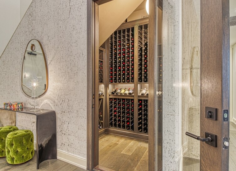 a view of an open doorway to a floor-to-ceiling wine cellar