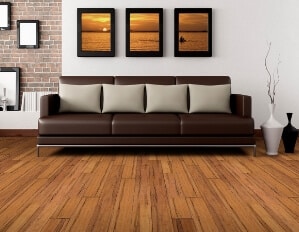a view of a living area with a brown leather couch and pictures on the wall