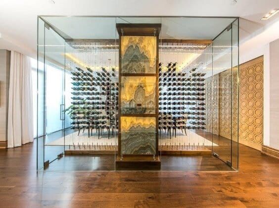 a modern wine cellar with all glass walls and doors