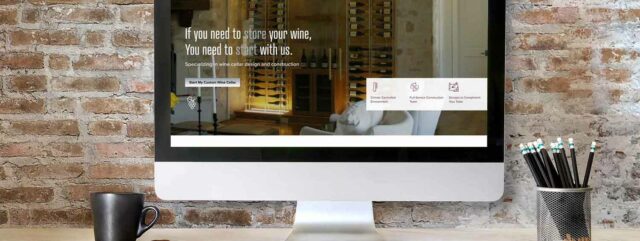 iMac on desk showing new Certified Wine Cellars on screen